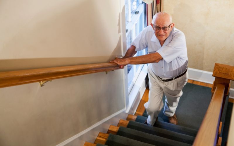 senior climbing stairs